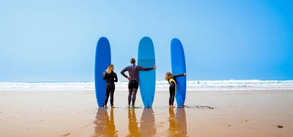 Stock image Happy family with surfboard on the beach