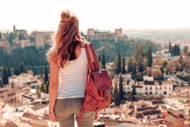 Woman tourist looking at Ancient arabic fortress Alhambra- Granada in Spain