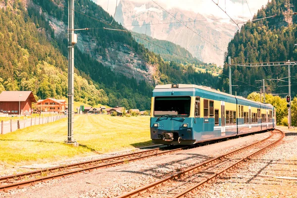 stock image Passenger train in countryside landscape in Switzerland
