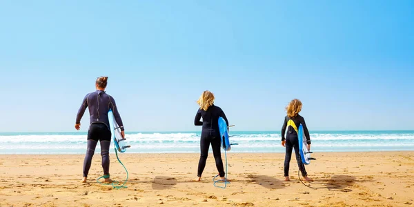 stock image Family, fether and son with surfboard on the beach