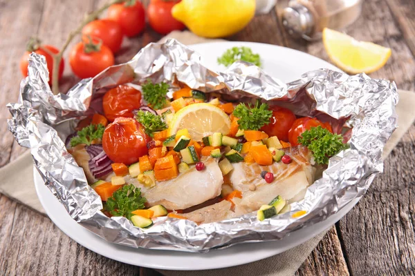 stock image baked fish in oil with vegetables