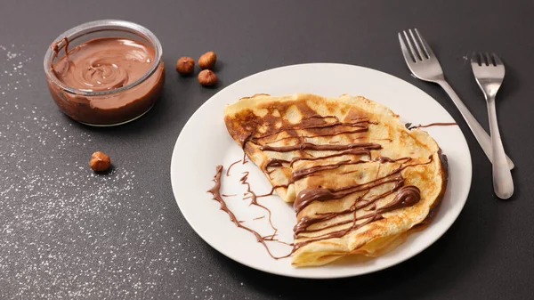 crepe with chocolate spread in plate