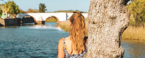 stock image Woman looking at the old bridge- Algarve in Portugal, city of Silves