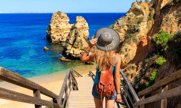 Woman tourist visiting Portugal- Beach praia do camilo near Lagos,  in Algarve- vacation, travel, summer holiday concept