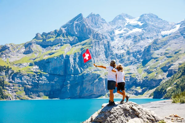 Two Brothers Holding Swiss Flag Oeschinen Lake Swiss Alps Mountain — Stock Photo, Image