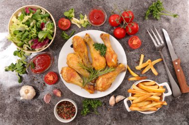 Kızarmış tavuk budu, salata ve patates kızartması.