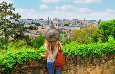 Panoramic view of Poitiers- Woman with hat and bag looking at city view- France clipart