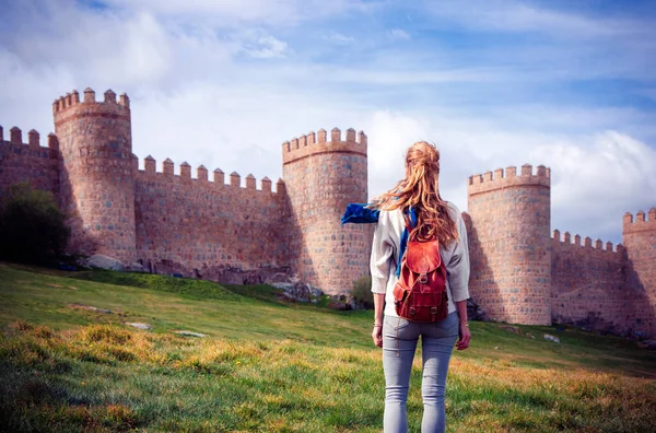 stock image Woman tourist enjoying view of Avila surrounding wall in Spain- Castile and Leon