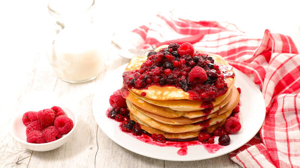 stack of pancakes with fresh berries fruits