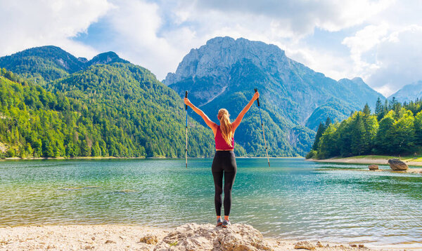 Hiker woman enjoying mountain lake- Pedril lake in Italy- sport, happiness,travel in Europe