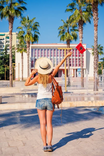Young woman holding Albanian flag in Tirana city of Albania- Travel, tour tourism concept