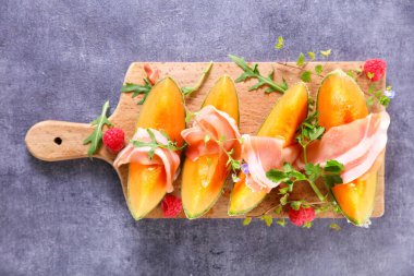 Tahtada taze kavun ve jambon.