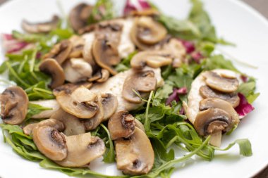 Fried champignons mushroom salad with chicken.