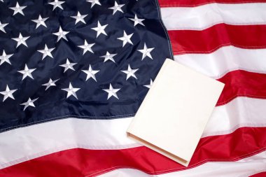 American Flag with white blank book. Flag of the USA.