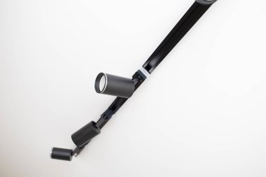 Black track spot Light on white stretch ceiling