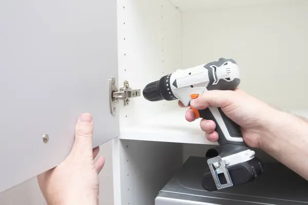 Worker Sets New Handle White Cabinet Screwdriver Installing Kitchen Cabinets Royalty Free Stock Images