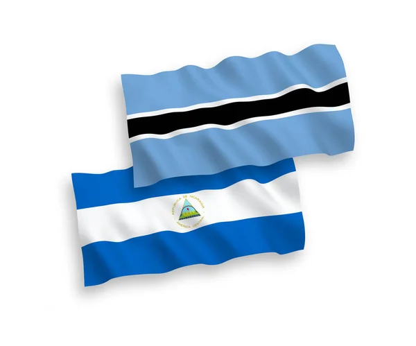 尼加拉瓜和博茨瓦纳在白色背景下孤立的国家病媒织物波浪旗 1比2的比例 — 图库矢量图片