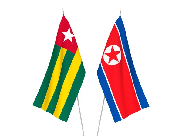 stock image National fabric flags of Togolese Republic and North Korea isolated on white background. 3d rendering illustration.