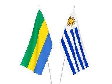 Gabon ve Uruguay Doğu Cumhuriyeti 'nin ulusal kumaş bayrakları beyaz arka planda izole edildi. 3d resimleme.
