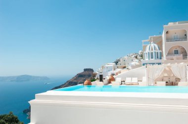 Santorini Adası, Yunanistan 'da beyaz mimari. Deniz manzaralı lüks yüzme havuzu. Seyahat ve yaz tatili kavramı