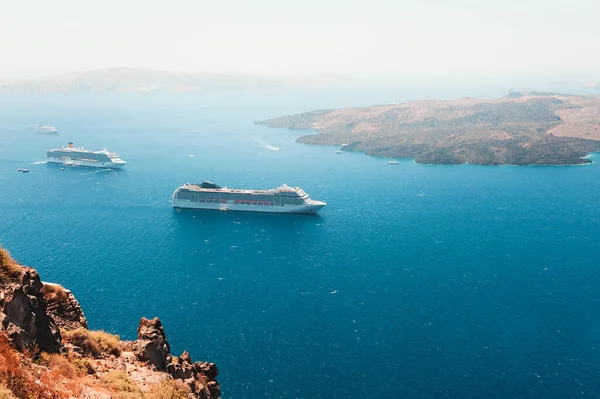 Santorini island, Greece. Cruise ships near the coast. Summer seascape. Travel and vacation concept
