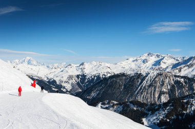 Ski resort in winter Alps mountains, France. Skiers ride on the ski slope. Meribel, France. Winter landscape