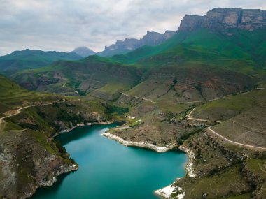 Gizhgit lake in the mountains at cloudy sunset. North Caucasus, Russia. Aerial drone view. Beautiful summer landscape.  clipart