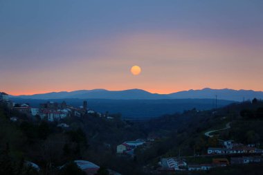 Bejar - old Spanish mountains city on sunset clipart