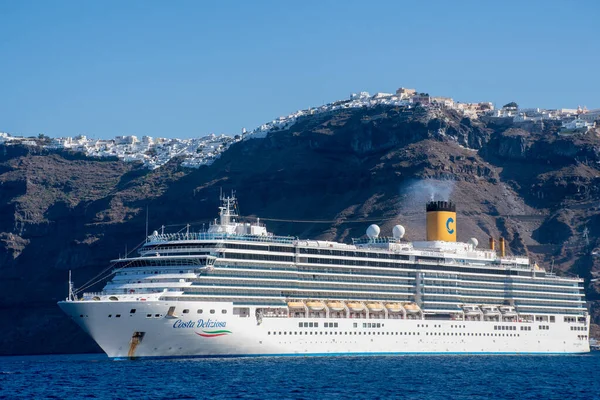 stock image Fira santorini Greece -28 September 2022:   Cruise Ship Costa Deliziosa of Costa cruises with Fira in background on top of cliffs