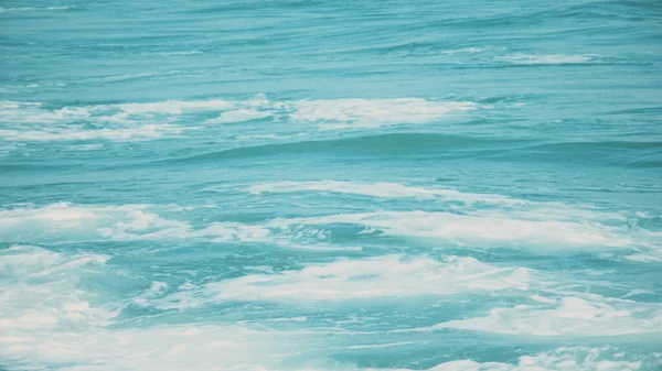 Blue background texture of the sea water. The surface of the sea.