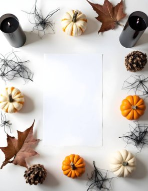 Halloween Flat Lay with Mini Pumpkins, Black Candles, Spider Webs, and Blank Paper on White Background clipart