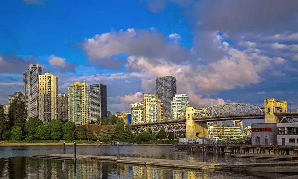 stock image Beautiful skyline of Vancouver city, Vancouver Harbor  Burrard Bridge and beach in Downtown on the background of blue cloudy stormy sky