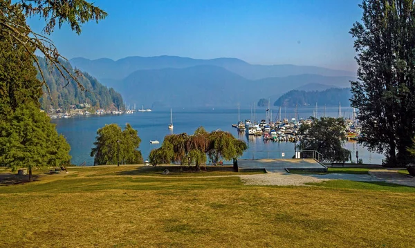 Village and marina  in Deep Cove in North Vancouver, bay, coastline, marine, speed boats, sailboats, people kayaking, recreation