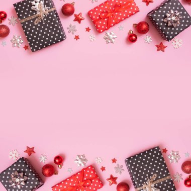 Noel hediyeleri pembe arka planda yatıyordu. Üst görünüm xmas hediyeleri kopya alanı ile dekorasyonlar.