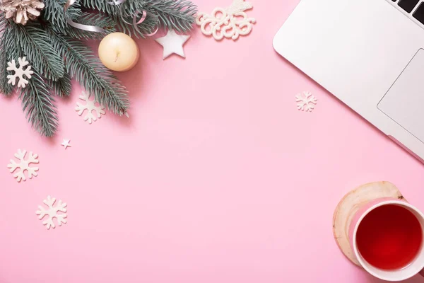 stock image Office work table with Christmas and New Year decoration top view, flat lay on pink background. Copy space for text during winter holidays.