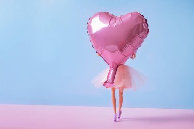 The doll with heart-shaped balloon. Valentine's Day creative concept. High quality photo