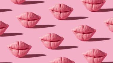 Moving pattern with pink lips with harsh shadows on a pink background. Creative motion with lips. High quality 4k footage
