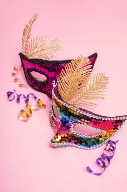 Festive face mask for carnival or masquerade celebration on colored background.