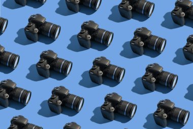 Pattern from many photo cameras on colored background. World Photography Day concept.