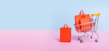 Valentines day sale shopping concept. Dall with shopping bags. Banner with copy space.