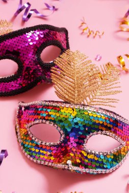 Festive face mask for carnival or masquerade celebration on colored background.