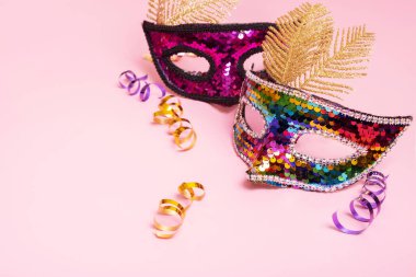 Festive mask for masquerade or carnival celebration on colored background.
