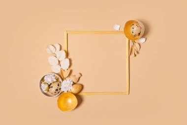 Frame with copy space and Easter eggs composition decorated with twigs and flowers. Easter flat lay monochrome.