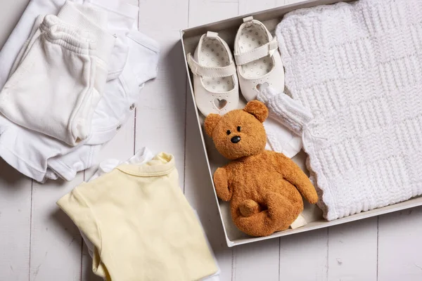 Childrens clothes, shoes and toys in box. Second hand, clothing recycling concept.