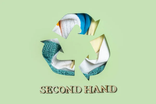 Second hand text and clothes under paper cut recycling symbol. Save planet, eco, recycling cloth concept.