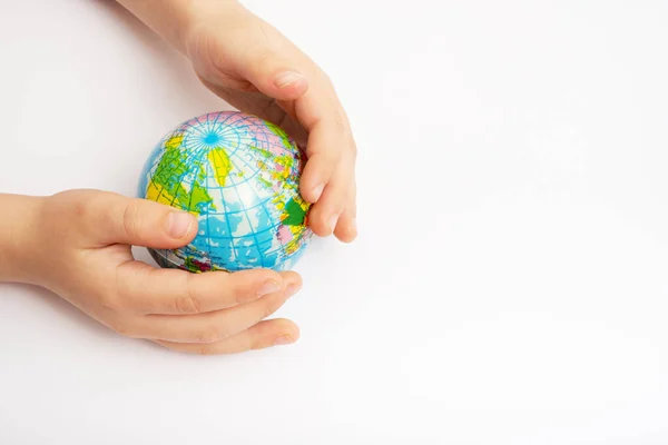 Environment for future, save the planet concept. World globe in child hands top view with copy space.
