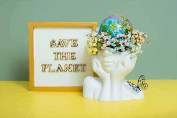 Save the planet text with world globe in head with flowers. Environment for the future, concept of saving the planet.