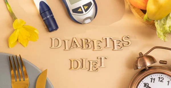 Diabetes diet text with plate and cutlery, glucose meter on beige background flat lay, top view. Banner