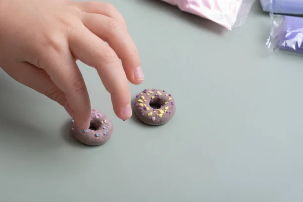 Creating a doll cake donut from air plasticine. Children\'s creativity DIY.
