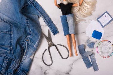 Giyinik kot şortlardan bebek kıyafetleri dikiyorum. Yeniden kullanım, geri dönüşüm konsepti.